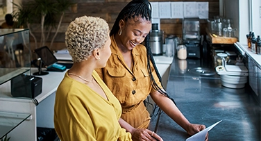 Two business owners looking at their POS system